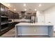 This gourmet kitchen features granite countertops, dark cabinets, stainless steel appliances, and lots of natural light at 361 Black Turnstone Ct, Las Vegas, NV 89138