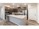 This open kitchen has stainless steel appliances, dark cabinets, and a center island at 361 Black Turnstone Ct, Las Vegas, NV 89138