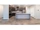 Modern kitchen featuring dark cabinets, stainless steel appliances, and a spacious island with seating at 361 Black Turnstone Ct, Las Vegas, NV 89138