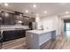 A modern kitchen featuring stainless steel appliances, a large island, and dark cabinetry at 361 Black Turnstone Ct, Las Vegas, NV 89138
