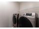 Laundry area featuring a side-by-side washer and dryer set with shelving above at 361 Black Turnstone Ct, Las Vegas, NV 89138
