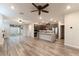 Open-concept living room and kitchen area with wood flooring and sliding glass doors to the outdoor space at 361 Black Turnstone Ct, Las Vegas, NV 89138