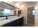 A modern main bathroom features a double vanity and a large mirror, and an open doorway at 361 Black Turnstone Ct, Las Vegas, NV 89138