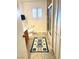 Bright bathroom with a window, tiled flooring, and a shower-tub combo at 3999 Delos Dr, Las Vegas, NV 89103