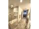 Well-lit bathroom featuring a clear glass shower with bench and modern fixtures at 3999 Delos Dr, Las Vegas, NV 89103