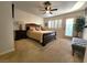 Well-lit bedroom featuring large bed, ceiling fan, and access to the outside at 3999 Delos Dr, Las Vegas, NV 89103