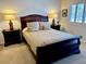Comfortable bedroom features a wood sleigh bed with luxury bedding and matching nightstands at 3999 Delos Dr, Las Vegas, NV 89103