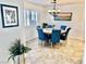Dining room with blue chairs, wood table, and shuttered window displays cozy charm at 3999 Delos Dr, Las Vegas, NV 89103