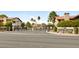 Gated community entrance with desert landscaping and lush trees around the perimeter at 3999 Delos Dr, Las Vegas, NV 89103