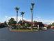 Well-manicured landscaping with palm trees surrounds this multi-story home on a cul-de-sac at 3999 Delos Dr, Las Vegas, NV 89103