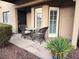 Quaint front porch featuring a bistro table and lush landscaping in front of the property at 3999 Delos Dr, Las Vegas, NV 89103