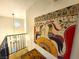 A view from the top of a carpeted staircase with decorative hanging light and artwork on the wall at 3999 Delos Dr, Las Vegas, NV 89103