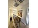 Bright hallway with staircase, decorative artwork, and access to multiple rooms at 3999 Delos Dr, Las Vegas, NV 89103