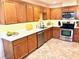 Kitchen features oak cabinets, stainless steel appliances, and bright white countertops at 3999 Delos Dr, Las Vegas, NV 89103