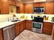 Traditional kitchen with stainless steel appliances, wood cabinets, and light countertops at 3999 Delos Dr, Las Vegas, NV 89103