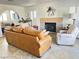 Spacious living room features a stone fireplace, natural light, and tile flooring, creating a warm ambiance at 3999 Delos Dr, Las Vegas, NV 89103