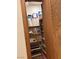 Walk-in pantry with wooden shelves stocked with paper towels, snacks, and drinks at 3999 Delos Dr, Las Vegas, NV 89103