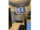 This kitchen features tile flooring, neutral cabinets, and granite countertops at 4200 Coran Ln, Las Vegas, NV 89108
