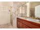 Elegant bathroom featuring a double sink vanity, marble walls and shower at 4245 N Campbell Rd, Las Vegas, NV 89129