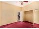 Spacious bedroom featuring plush carpet, a ceiling fan, and closet access offering comfort and convenience at 4245 N Campbell Rd, Las Vegas, NV 89129