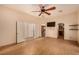 Well lit bedroom with ceiling fan, wall mounted TV, and access to adjacent rooms, blending comfort and convenience at 4245 N Campbell Rd, Las Vegas, NV 89129