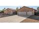 Home's front exterior features large two-car garage, decorative window and iron gate at 4245 N Campbell Rd, Las Vegas, NV 89129