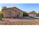Single-story home featuring a three-car garage, desert landscaping, and attractive architectural details at 4245 N Campbell Rd, Las Vegas, NV 89129