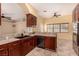 Warm kitchen offers dual sink, lots of prep space, and dark brown wood cabinets at 4245 N Campbell Rd, Las Vegas, NV 89129