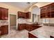 Traditional kitchen features tiled counters and floors, and dark wood cabinetry at 4245 N Campbell Rd, Las Vegas, NV 89129