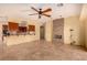 Spacious living room with tile flooring, ceiling fan, and stone fireplace feature at 4245 N Campbell Rd, Las Vegas, NV 89129
