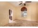 Neutral living room with light walls, tile flooring, a ceiling fan, and a window providing natural light at 4245 N Campbell Rd, Las Vegas, NV 89129