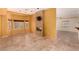 Open living room with tile floors, stone fireplace feature, and large windows at 4245 N Campbell Rd, Las Vegas, NV 89129