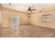 Spacious living room features tile flooring, a ceiling fan and natural light from the large sliding glass door at 4245 N Campbell Rd, Las Vegas, NV 89129