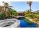 Backyard pool and hot tub surrounded by tropical landscaping at 4245 N Campbell Rd, Las Vegas, NV 89129