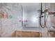A marble-tiled shower and bath in a modernly designed bathroom space at 4381 W Flamingo Rd # 3007, Las Vegas, NV 89103