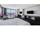 Stylish bedroom featuring a large bed, workspace, and city views at 4381 W Flamingo Rd # 3007, Las Vegas, NV 89103