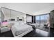 Sophisticated bedroom featuring a mirrored wall, modern furniture, and a glimpse of the city view at 4381 W Flamingo Rd # 3007, Las Vegas, NV 89103