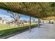 Covered back patio offering shade and views of the well-manicured backyard and pool at 4530 W Maulding Ave, Las Vegas, NV 89139