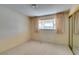 Neutral bedroom featuring carpet flooring, large window with curtains, and mirror closet doors at 4530 W Maulding Ave, Las Vegas, NV 89139