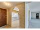 View of entryway with curved wall arches, neutral wall colors and views of living spaces at 4530 W Maulding Ave, Las Vegas, NV 89139