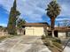 Attached two-car garage with manicured landscaping at 4530 W Maulding Ave, Las Vegas, NV 89139