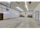 Large garage space with concrete floors, built-in shelves, and overhead doors at 4530 W Maulding Ave, Las Vegas, NV 89139