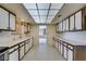 Galley kitchen featuring ample cabinets and countertops, and tile flooring at 4530 W Maulding Ave, Las Vegas, NV 89139