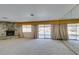 Bright living room with stone fireplace, pool view and wall mirror at 4530 W Maulding Ave, Las Vegas, NV 89139