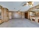 Spacious living room with unique bar, two ceiling fans, and wood paneled wall accents at 4530 W Maulding Ave, Las Vegas, NV 89139
