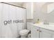 Bathroom featuring toilet, sink, mirror, and a shower with a cheeky curtain at 5015 Spencer St # C, Las Vegas, NV 89119