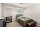 Neutral bedroom featuring carpet, a twin bed, storage bench, and small storage shelf at 5015 Spencer St # C, Las Vegas, NV 89119