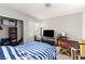 Bedroom with closet, a bed, carpet, a television, desk and window at 5015 Spencer St # C, Las Vegas, NV 89119