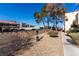 A community dog park area with gravel, landscaping, and pet waste station at 5015 Spencer St # C, Las Vegas, NV 89119