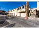 View of exterior units with individual garages in a well-maintained community on a sunny day at 5015 Spencer St # C, Las Vegas, NV 89119